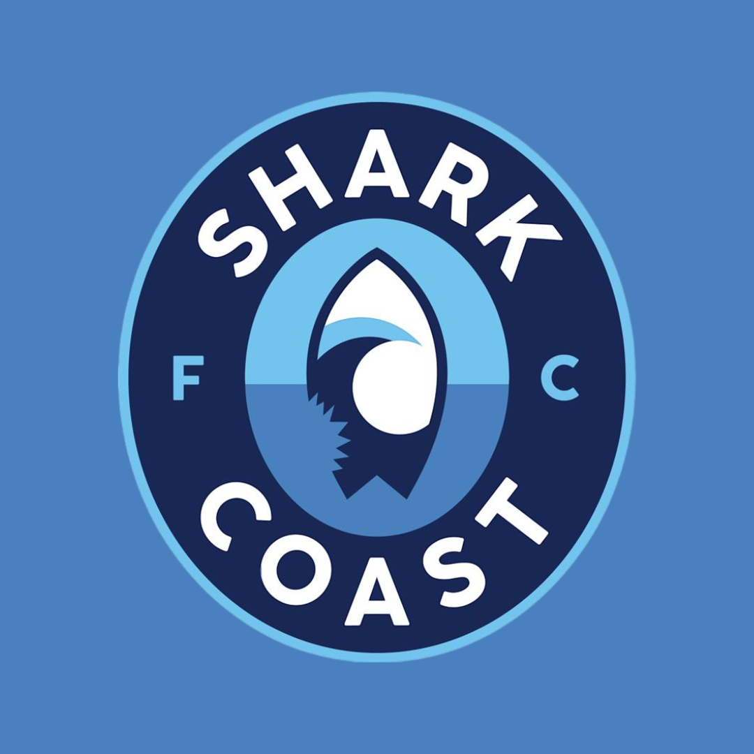 Shark Coast FC logo on blue backdrop